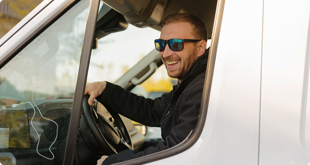 someone in the drivers seat of a white work van