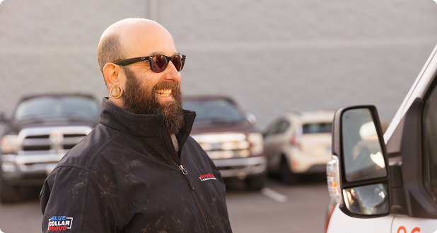 someone smiles and looks at a white work van