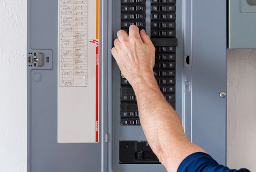 Reynolds electrician checking electrical panel